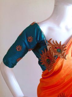 "Stunning orange semi raw silk (duiponi silk)saree with beautiful peacock motif hand embroidery and raw silk unstiched blouse in deep blue green, also with matching embroidery. The orange color is simply stunning when paired with dark blue green and matching tassels add the perfect unique touch Saree length 5.5 meters Blouse fabric 1 meter 44\" wide Saree ships in 2-3 days of payment.Shipping time is 4-7 days via fedex . We also offer blouse and petticoat stitching for saree as additional servic Orange Raw Silk Blouse Piece With Zari Work, Designer Peacock Design Traditional Saree, Orange Dola Silk Blouse Piece, Green Saree With Peacock Design In Traditional Drape, Festive Green Saree With Peacock Design, Bollywood Green Saree With Peacock Design, Green Saree With Peacock Design For Festivals, Raw Silk Saree With Peacock Design, Festive Raw Silk Traditional Wear With Peacock Design