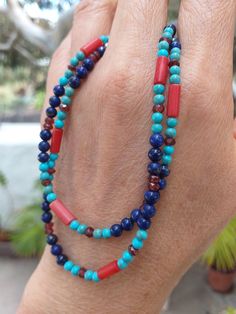 A Boho style Necklace made of multi gemstone.  We have Lapis Lazuli, Blue Turquoise, Matte Finished Red Coral(Sea Bamboo) and Garnet in this necklace. Width of the necklace is 4mm. (0.14")    Clasp is a 925 Sterling Lobster Clasp. Length is 17.5" or 44.5cm. Weight is 10 grams.  Stringing is on Soft Flex - Soft Touch 49 Strands beading wire for máximum strength and flexibility. Photos are close-up, so check actual size carefully. Color varies with monitor. Shipping is from the Canary Islands, Spain. (Please see Shipping & Policy) A Reminder:  Any of our listings on Solitary Mountain can be combined with any of our listings on Peridot Mountain. https://www.etsy.com/shop/PeridotMountain?ref=hdr_shop_menu Simply request Custom Listing. Yesterday climbed to the top of the volcano Guardilama, fr Artisan Multi-stone Turquoise Necklace, Artisan Blue Multi-stone Turquoise Necklace, Artisan Blue Turquoise Multi-stone Necklace, Southwestern Blue Gemstone Necklace, Blue Double Strand Gemstone Beads Jewelry, Blue Double Strand Natural Stones Jewelry, Blue Round Beads Fusion Jewelry, Southwestern Blue Beaded Necklaces For Gift, Southwestern Style Blue Beaded Necklace For Gift