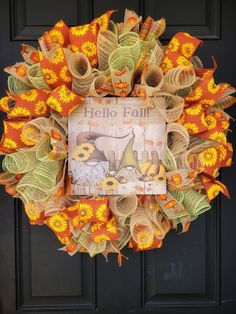 an orange and yellow wreath with the words hello fall on it