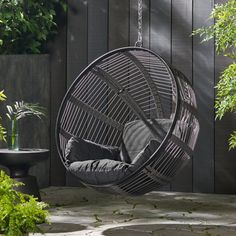 a hanging chair in the middle of a patio