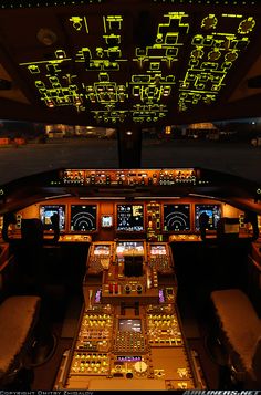 the cockpit of an airplane with illuminated lights