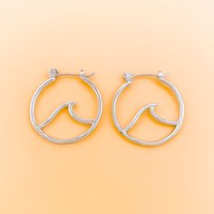 Stunning and refined, the Wave Hoop Earrings elegantly captures the essence of the ocean. These earrings are the perfect keepsake for your favorite beach–lover. Details: Rhodium Plated over Brass Hoop Size 25mm in Diameter Elegant Sterling Silver Hoop Earrings For Summer, Elegant Small Hoop Jewelry For The Beach, Elegant Small Hoop Earrings For Beach, Elegant Small Hoop Jewelry For Beach, Hypoallergenic Hoop Jewelry For Summer, Elegant Round Hoop Earrings For The Beach, Silver Hoop Jewelry For Beach, Silver Hoop Jewelry For The Beach, Silver Hoop Earrings For The Beach