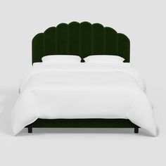 a bed with a green headboard and white sheets on it's sides, in front of a gray background