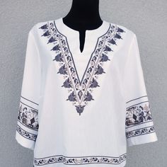 "Experience the freedom and style of our Large Hippie Blouse. Crafted with love and attention to detail, this boho top blouse is the perfect addition to your summer wardrobe. With exquisite embroidery and vibrant colors, it exudes a carefree and joyful vibe that is perfect for any hippie festival or a casual outing. Made from high-quality materials, it offers both comfort and durability. Embrace the bohemian spirit and make a statement with our women's embroidered summer shirt. Elevate your fashion game and feel confident in this unique and eye-catching piece of clothing. Get ready to turn heads and stand out from the crowd with our trendy hippie festival clothes. Very beautiful white with brown/beige colors vintage blouse. Has a producer label. Half long sleeves. A side small slits. The f Bohemian V-neck Embroidered Top, Bohemian Long Sleeve Embroidered Top For Vacation, Folk Style V-neck Blouse With Embroidered Neckline, Summer Embroidered V-neck Peasant Top, Bohemian Embroidered Relaxed Fit Blouse, Bohemian Cotton V-neck Top, Spring Bohemian Embroidered Top, Bohemian Long Sleeve Embroidered Top For Beach, Bohemian Tops With Geometric Embroidery