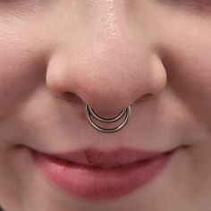 a close up of a person with a nose ring