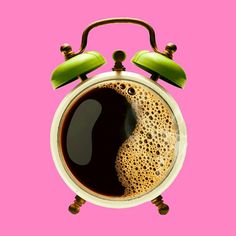 an alarm clock with a cup of coffee in the middle on a pink background,