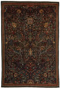 an antique rug with trees and flowers on it