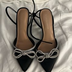 Bcbgeneration Black Heels With Silver Bedazzled Bows And Straps New And Never Worn Size 7.5 Black Heels Silver Bow, Black Ribbon Heels, Black Heels With Silver Bow, Black Heel With Bow, Silver And Black Heels, Pretty Shoes Aesthetic, Black Hoco Heels, Black Heels For Prom, Anita Torres