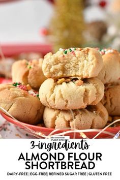 three ingredient almond flour shortbread cookies stacked on top of each other in a red bowl