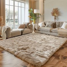 a living room filled with furniture and a large rug on top of a hard wood floor