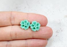 Sakura Blossom Earrings - pretty flower earrings on stainless steel posts. This listing is for the Blossom Earrings in mint green. Stud earrings are about 12mm in size. (about 1/2 inch)Click here to go back to my shop: http://lotusandbliss.etsy.com Green Stud Earrings, Sakura Blossoms, Mint Green Earrings, Earrings Pretty, Pretty Flower, Earrings Green, Green Flower, Green Earrings, Botanical Flowers