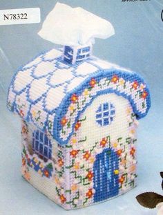 a cross stitch house with a tissue dispenser on the front and side