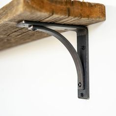 a wooden shelf with metal brackets on it