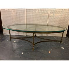 a glass and metal coffee table on the floor