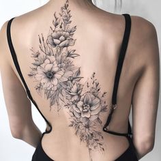 the back of a woman's body with flowers on it