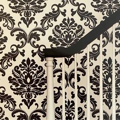 a black and white wallpapered stair case