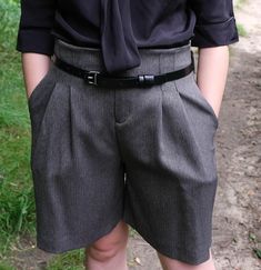 a person wearing shorts and a tie standing in the grass