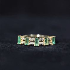 Product Details This Double Row Eternity Band boasts a simple yet striking hue of Five Baguette Cut Emerald set in a distance with the sparkling Diamond. The timeless craftsmanship of this Emerald and Diamond Wedding Ring is perfect for adding a touch of elegance to any special occasion. Being rich green the Emerald gemstone exhibits brilliance with the Diamond accompanying this Baguette Anniversary Band. Often associated with luck and hope for a new beginning this Emerald Baguette Wedding Band Diamond And Emerald Ring, Emerald Band Ring, Baguette Wedding Band, Being Rich, Emerald Wedding Band, Ring With Emerald, Emerald Set, Emerald Band, Infinity Ring Wedding