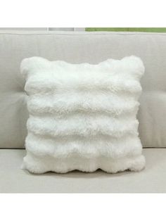 a white pillow sitting on top of a couch