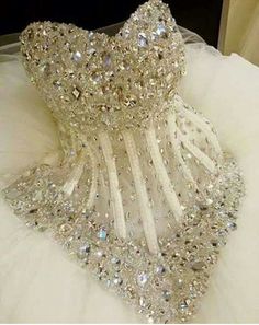 a white dress with lots of crystals on it