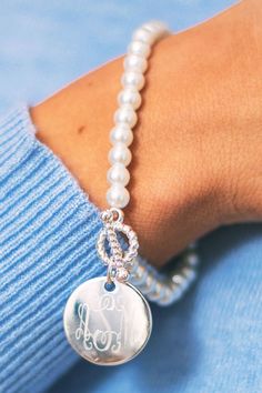 Looking for a sweet and classic bracelet to give a special woman in your life? This Monogrammed Pearl Bracelet with a 7/8 inch charm and faux pearl beads is the perfect piece to make her feel special. Personalize it with her initials in the font of your choice. This bracelet has a stretchy fit so that it can fit almost any wrist. Elegant Personalized Charm Bracelet, Adjustable White Monogram Jewelry, Elegant White Monogram Jewelry, Elegant Silver Charm Bracelet For Personalized Gift, Elegant Sterling Silver Charm Bracelet For Personalized Gift, Elegant Hypoallergenic Name Bracelet As Personalized Gift, Elegant Monogram Name Bracelet As Personalized Gift, Elegant Monogram Name Bracelet For Personalized Gift, Elegant Monogrammed Name Bracelet For Personalized Gift