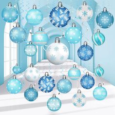 blue and white christmas ornaments hanging from the ceiling in front of a window with snowflakes on it