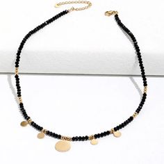 This one-of-a-kind Tori Black Beaded Necklace is sure to catch eyes with its bold mix of edgy black and glitzy gold. A shimmering statement piece for daring fashionistas, it'll add a modern touch to any look! #stylegameonpoint Size: 16 inches with 2 inch extender Materials: Stainless Steel 18K Gold Plated Metal Beaded Necklaces With Round Beads For Party, Party Beaded Necklace With Metal Beads, Party Beaded Chain Necklace With Metal Beads, Party Metal Beaded Chain Necklaces, Trendy Black Beaded Necklaces With Round Beads, Trendy Metal Beaded Choker Necklace, Gold Necklaces With Black Beads For Party, Party Beaded Necklaces With Faceted Metal Beads, Black Faceted Beads Choker