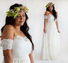 a woman wearing a white dress with flowers in her hair