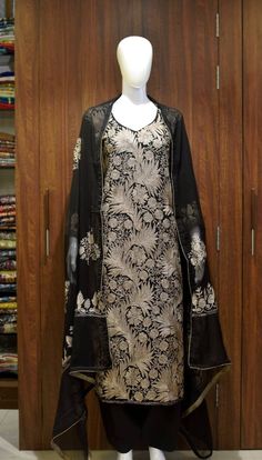 A stunningly marvellous outfit. This outfit features intricate Kashmir aari embroidery with silk thread on all over the shirt front, on sleeves and 2 sided embroidery border on the dupatta with all over booties of same work.- - - - - - - - - - - - - - - - - - - - Product DetailsCondition: Brand NewF A B R I CShirt: Viscose GeorgetteDupatta: ChiffonLower: Indian CrepeF I N I S HUnstitched/Semi-StitchedYou can get it stitched locally.47+ inches of Shirt Length and upto full sleeves length.Stitched Raw Silk Churidar With Dupatta, Silk Kurta With Chikankari Embroidery For Navratri, Silk Sets With Chikankari Embroidery, Traditional Drape Churidar With Floral Embroidery In Cotton Silk, Traditional Drape Churidar With Floral Embroidery, Elegant Churidar With Floral Embroidery In Chanderi, Cotton Silk Churidar With Floral Embroidery, Festive Chanderi Kurta With Floral Embroidery, Designer Floral Embroidery Kurta For Transitional Season