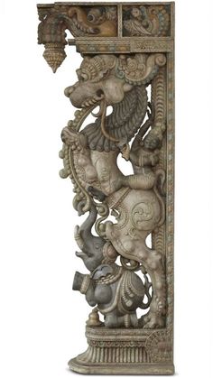 an intricately carved sculpture with elephants and birds on it's sides, against a white background