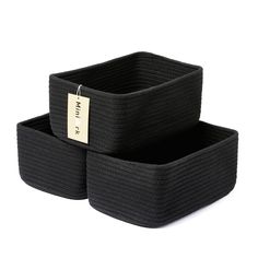 two black storage baskets sitting on top of each other