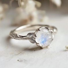 **Make a sparkling statement with this natural inspired Moonstone Engagement Ring at your next event. It's crafted in sterling silver, Gold/White Gold/Rose Gold bands. This ring is beautifully decorated with genuine Moonstones.  Gem:  Moonstone 8mm *This is a listing for one Moonstone Engagement Ring. We will carefully select a stone and make the piece for you.  Keep in mind, every piece we create is one-of-kind, with raw stones that differ in size, shape, and color. When ordering, anticipate so 2022 Rings, Twig Ring, Jewelry Aesthetic, Moonstone Engagement, Semi Precious Gems, Moonstone Engagement Ring, Rings Rings, Floral Ring, Rainbow Moonstone Ring