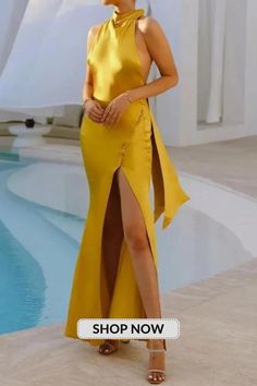 a woman standing in front of a pool wearing a yellow dress with high slits