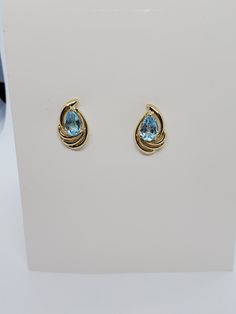 You are viewing a beautiful 14k solid gold topaz earrings. Pierced styleback. The total weight of the earrings approx.3.08 grams. Each earrings measures approx.17mm x 1mm wide. Marked 14k at the back. The earrings is in good condition. Formal Blue Topaz Diamond Earrings Fine Jewelry, Formal Blue Topaz Diamond Earrings, Formal Yellow Gold Topaz Earrings, Yellow Gold Topaz Earrings, Round Shape, Blue Oval 14k Gold Earrings, Oval Blue 14k Gold Earrings, Formal Topaz Earrings, Blue Topaz Fine Jewelry Earrings For Formal Occasions, Yellow Gold Earrings With Blue Topaz Gemstone