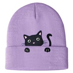 a purple beanie hat with a black cat on it's face and eyes