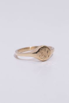 A classic hand engraved monogram ring. Solid 14k recycled gold. Signet face is 7.8mm round, and tapers to a 2.2mm band. 1-2 letters of your choosing engraved into the face. If you would like diamonds or other small birthstones inlaid into the ring, contact us here with the special request. This ring is made to order, please allow 3-4 weeks for delivery. Personalized Initial Ring In 14k Gold With Round Band, Personalized 14k Gold Initial Ring With Round Band, Personalized Engraved 14k Gold Ring, Minimalist 14k Gold Engraved Ring With Initials, Minimalist 14k Gold Monogram Rings, Timeless 14k Gold Initial Ring, Minimalist Monogram 14k Gold Rings, Wedding 14k Gold Signet Ring With Round Cut, Timeless 14k Gold Tarnish Resistant Initial Ring