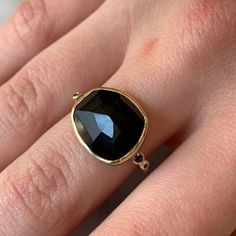 A rosecut black spinel is set in 14k yellow gold between a pair of 3pt and 1pt black diamonds on a hand textured sterling silver band. The simplicity of this ring makes it a great everyday piece that can be worn with any outfit, from jeans to black tie. It's an excellent choice for someone who feels that color is an unnecessary addition to their wardrobe. Approximate stone size: 15mm x 12mm Approx CTW: 8cts Mohs hardness: 8 This one of a kind piece is handmade to order in Emily's Hudson Valley s Minimalist Jewelry With Black Diamonds And Black Spinel, Black Fine Jewelry Rings For Everyday, Everyday Black Fine Jewelry Ring, Everyday Fine Black Ring, Classic Black Spinel Ring With Black Diamonds, Black Diamond And Spinel Promise Ring, Black Spinel Jewelry With Rose Cut Diamonds For Gift, Gift Jewelry With Rose Cut Diamonds And Black Spinel, Anniversary Rings With Black Diamonds And Spinel