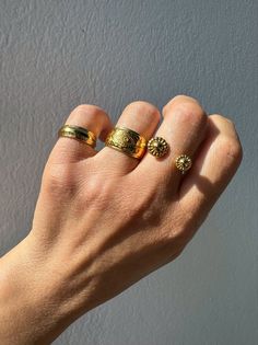 Elevate your style with our exquisite collection of gold stacking rings, exclusively available at Christina Christi Store. Crafted to perfection, this set features a medium-width ring with engraved edges, a mesmerizing evil eye design on the middle ring, and a uniquely stunning ring with two spheres at the edges. Each ring is slightly adjustable for a comfortable fit on any finger. With a diameter of 17mm (0.67'') or US size 7, these rings are versatile for any occasion. Please note that each ri Yellow Gold Brass Stackable Rings, Yellow Gold Brass Stackable Promise Rings, Gold Midi Rings Of Recycled Gold, Yellow Gold Brass Toe Stackable Rings, Everyday Gold Open Engraved Ring, Classic Gold Stackable Brass Rings, Gold Brass Rings Fine Jewelry, Gold Brass Rings In Fine Jewelry Style, Gold Brass Fine Jewelry Rings