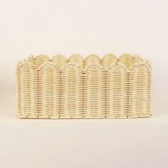 a white wicker basket sitting on top of a table