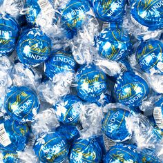 blue and white candies wrapped in plastic wrapper on top of eachother