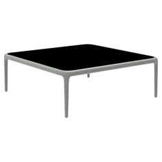 a black table sitting on top of a white floor