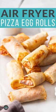 air fryer pizza egg rolls on a white plate with text overlay that says air fryer pizza egg rolls