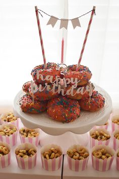 a birthday cake and cupcakes on a table