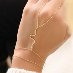 The epitome of dainty design, this hand chain is a symphony of delicate craftsmanship where silver meets sparkle. Perfect for the fashion-forward spirit, it’s a minimalist aesthetic piece that doesn’t shout but rather speaks in a language of style and sophistication. Metal: 925 sterling silver Coating: 18k gold Gemstones: cubic zirconia Wrist length: adjustable 6-7.5in + 1.5in chain extender Chain: cable link Clasp: spring ring Hypoallergenic, nickel-free, and anti-tarnish Don’t forget, proper care of your gold-plated jewelry will preserve its appearance for a long time. Keep it shining bright by using the soft side of the provided JFW polishing cloth Delicate Adjustable Chain Bracelet In Rose Gold, Delicate Adjustable Rose Gold Chain Bracelet, Delicate Rose Gold Adjustable Chain Bracelet, Delicate Yellow Gold Jewelry For Party, Delicate Yellow Gold Party Jewelry, Elegant Sterling Silver Chain Bracelet For Party, Elegant Snake Chain Jewelry For Party, Delicate Sterling Silver Adjustable Chain Bracelet, Dainty Sterling Silver Chain Bracelet For Party