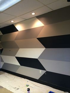 a room that has been painted black and white with some paint on the wall next to it