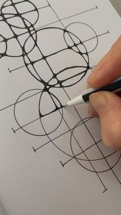 a person is drawing on a piece of paper