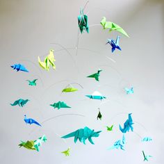 a group of origami birds flying in the sky