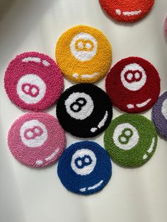 eight ball markers with smiley faces on them are arranged in the shape of an eight ball