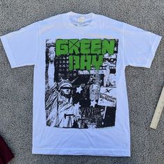 Up For Sale Is A - Green Day Shirt Band Tee Size: Mens Small Measurements:Please See Photos Above For All Measurements Good Used Condition Nice Logo I Will Ship This Item Out Via Usps 2-3 Day Mail With A Tracking Number For Confirmationi Ship Items Out Every Day So Expect A Quick Delivery!Please Feel Free To Ask Any Questions You May Havei Answer Most Questions Instantly!All Clothing Has Been Cleaned Per Ebay Policies D111 Punk Style Graphic Print Shirt For Summer, Punk Style Graphic Print Summer Shirt, Summer Streetwear Shirt With Band Logo, White Grunge Shirt For Concert, Punk Style Graphic Print Shirt For Concert, Punk Style Graphic Shirt For Concerts, Summer Grunge Concert Shirt, Grunge Fan Merchandise Shirt With Screen Print, Grunge Style Fan Merchandise Shirt With Screen Print