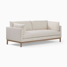 a white couch sitting on top of a wooden frame